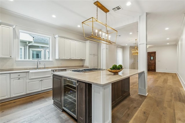 kitchen featuring a center island, wine cooler, and white cabinets