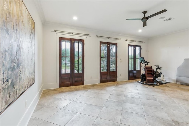 foyer with light tile patterned floors, crown molding, and french doors