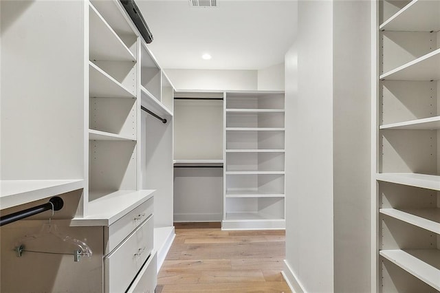 spacious closet featuring light hardwood / wood-style floors