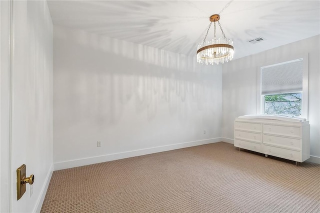 interior space featuring carpet floors and a chandelier