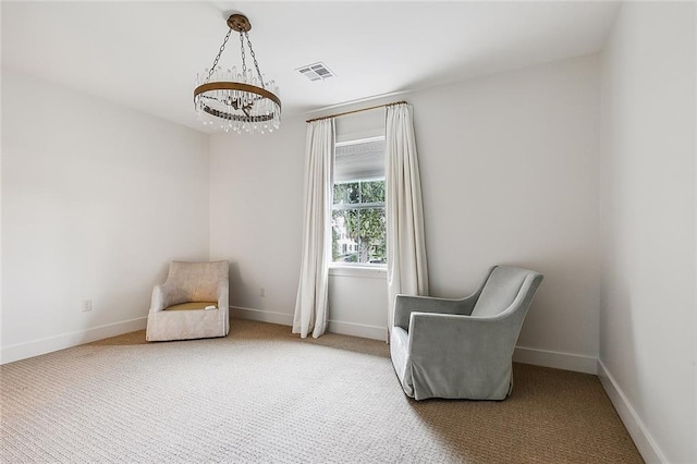 living area with carpet and a notable chandelier