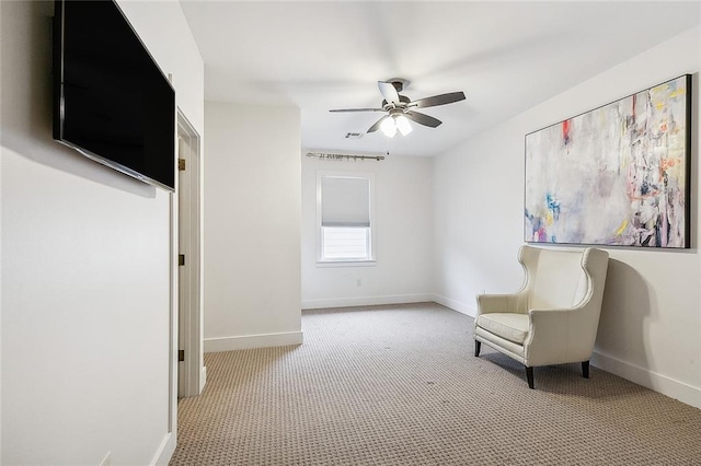 unfurnished room with light colored carpet and ceiling fan