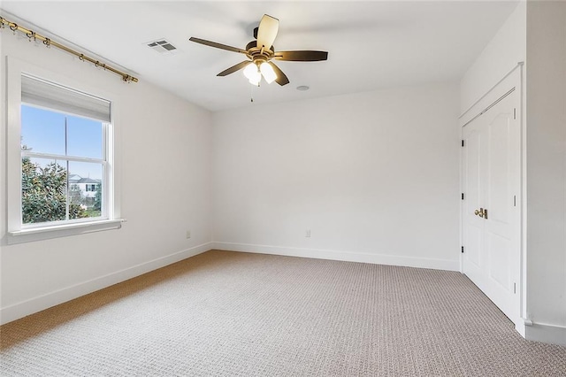 spare room featuring ceiling fan and carpet floors