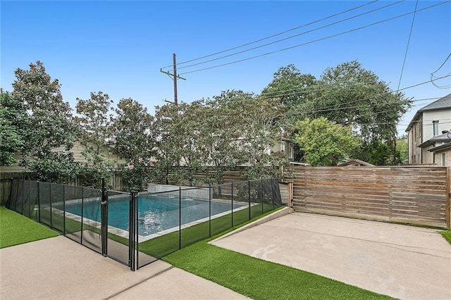 view of sport court featuring a fenced in pool and a patio area