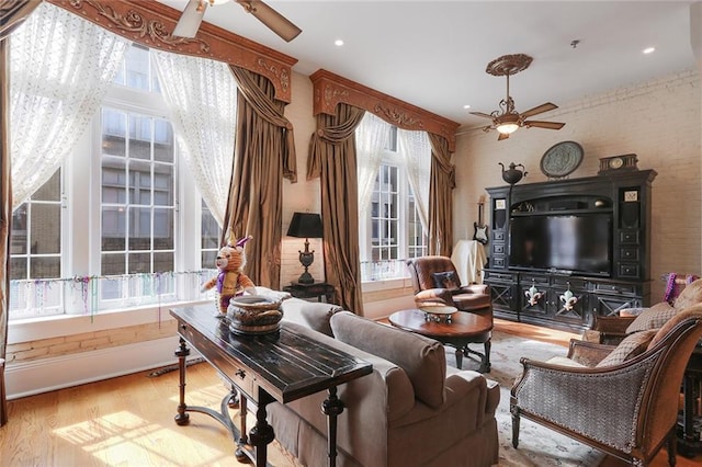 living room with ceiling fan and light hardwood / wood-style floors