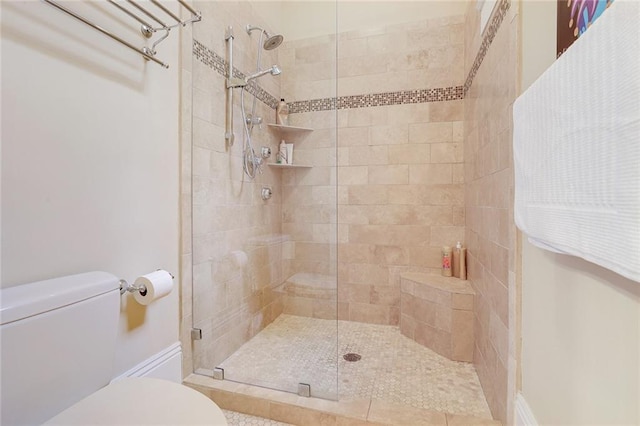 bathroom featuring toilet and an enclosed shower