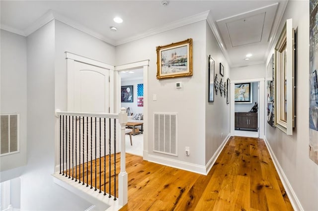 hall featuring ornamental molding and hardwood / wood-style floors