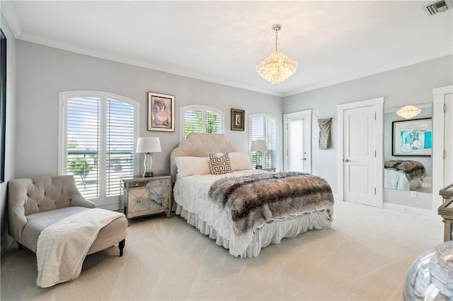 carpeted bedroom featuring ornamental molding and a notable chandelier