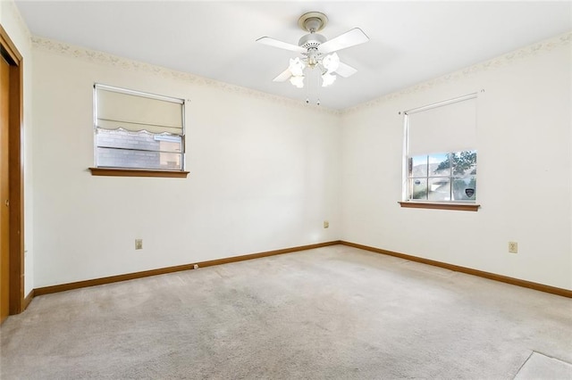 unfurnished room with ceiling fan and light carpet