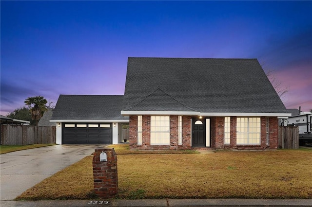 view of front facade with a garage and a lawn