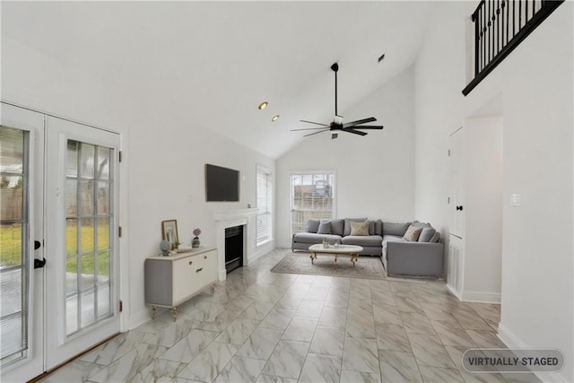 living room featuring vaulted ceiling, french doors, and ceiling fan