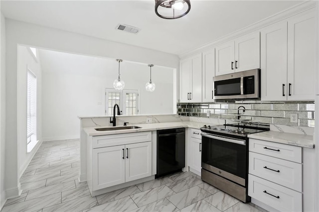 kitchen featuring sink, white cabinetry, kitchen peninsula, pendant lighting, and stainless steel appliances