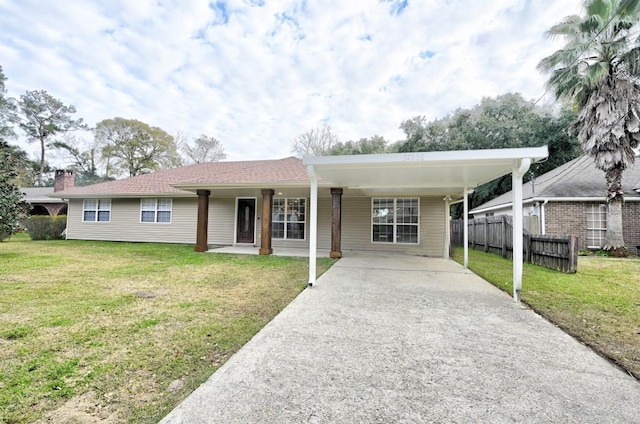 view of front facade featuring a carport and a front yard