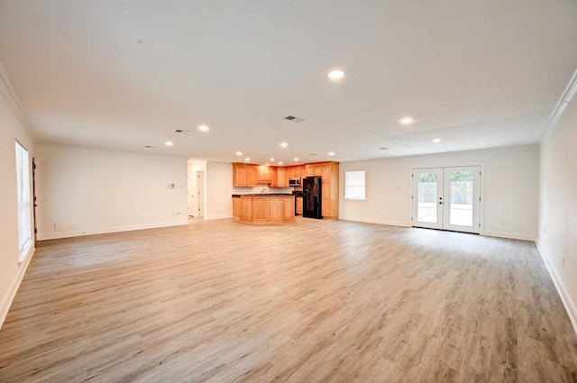 unfurnished living room with french doors, crown molding, and light hardwood / wood-style floors