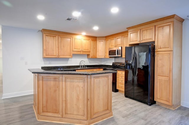 kitchen with sink, light brown cabinets, light hardwood / wood-style floors, and black appliances