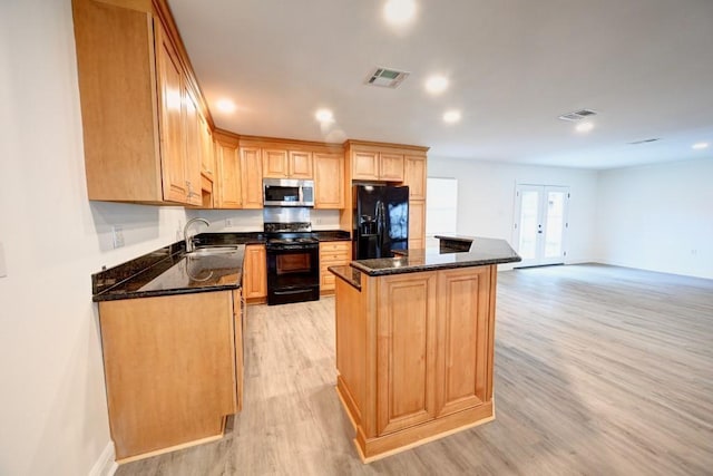 kitchen with french doors, sink, dark stone counters, light hardwood / wood-style floors, and black appliances