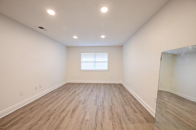 unfurnished room with light wood-type flooring