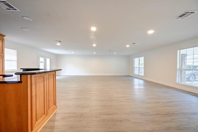 interior space featuring plenty of natural light and light hardwood / wood-style flooring