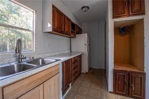 kitchen featuring white refrigerator and sink