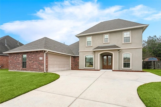 view of property featuring french doors, a garage, and a front lawn