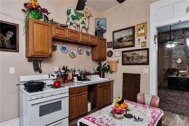 kitchen featuring wood-type flooring and white gas stove