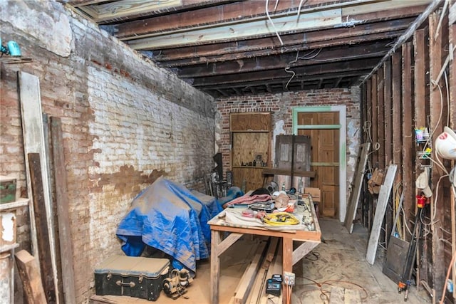 miscellaneous room featuring brick wall