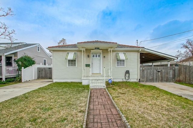 bungalow featuring a carport and a front lawn