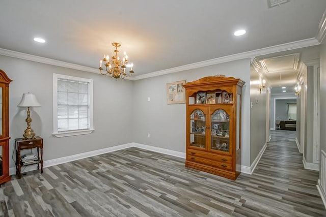 dining space with an inviting chandelier, crown molding, and hardwood / wood-style flooring