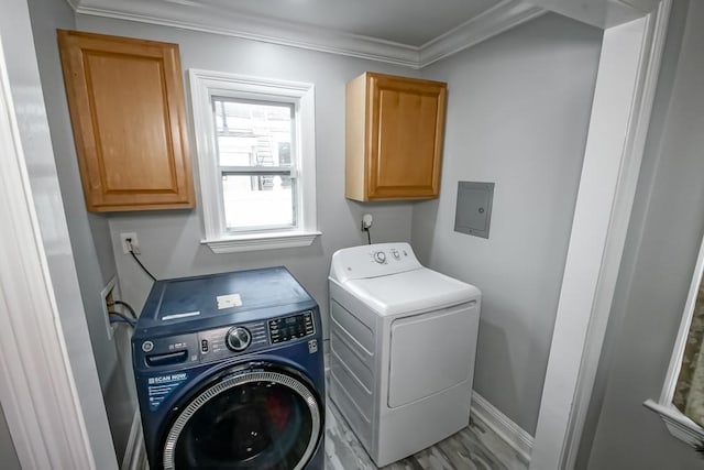 laundry area with cabinets, ornamental molding, washing machine and clothes dryer, light hardwood / wood-style floors, and electric panel