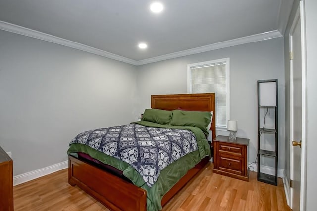 bedroom with ornamental molding and light wood-type flooring