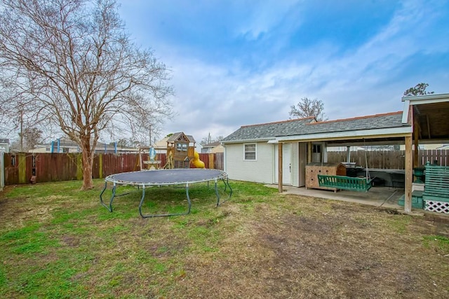 view of yard featuring a playground, a patio area, and a trampoline