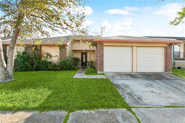 single story home featuring a garage and a front lawn