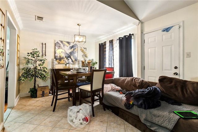 tiled dining area with lofted ceiling, ornamental molding, and a chandelier