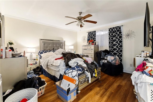 bedroom featuring ceiling fan, ornamental molding, and dark hardwood / wood-style flooring