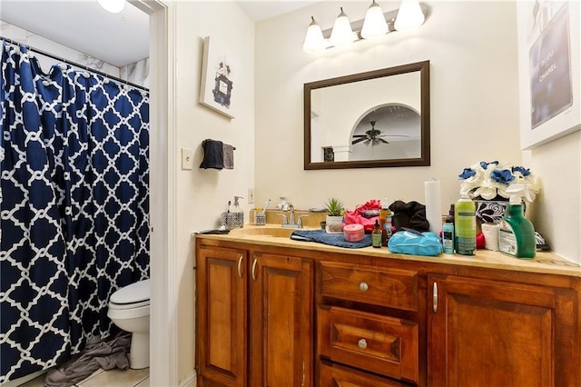 bathroom featuring vanity, tile patterned floors, and toilet