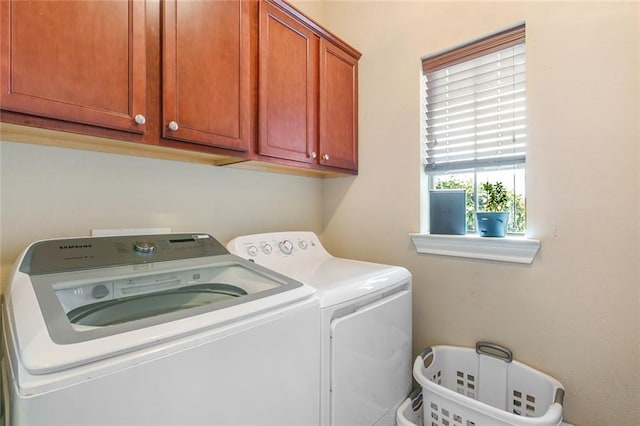 laundry area with cabinets and washing machine and dryer