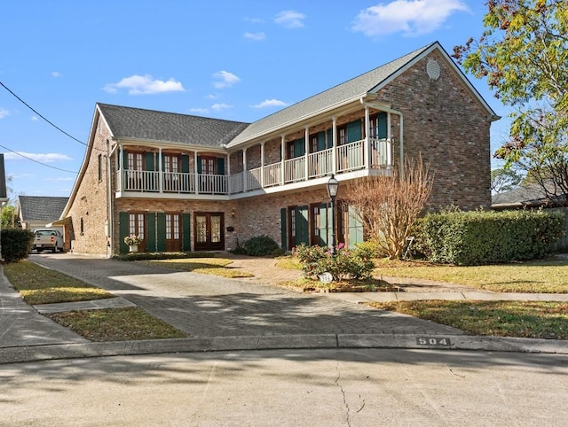 view of front property with a balcony