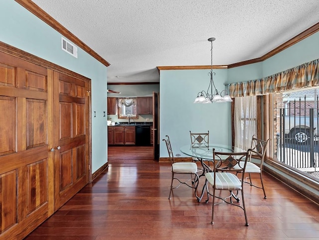 dining room with crown molding, a textured ceiling, and a chandelier