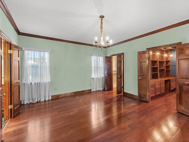 interior space with a textured ceiling, ornamental molding, dark hardwood / wood-style floors, and a chandelier