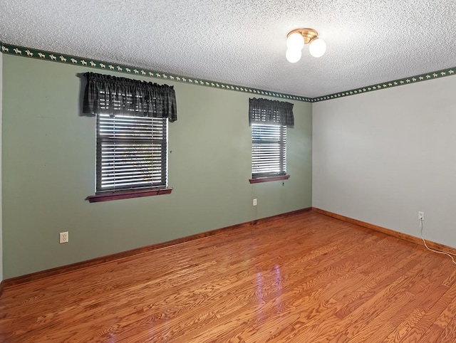 empty room featuring hardwood / wood-style floors and a textured ceiling