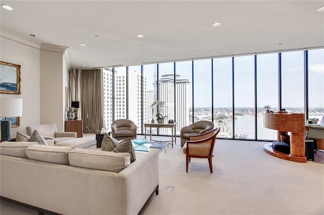 carpeted living room featuring expansive windows and ornamental molding