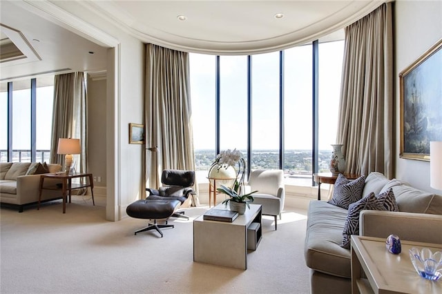 carpeted living room featuring crown molding and floor to ceiling windows