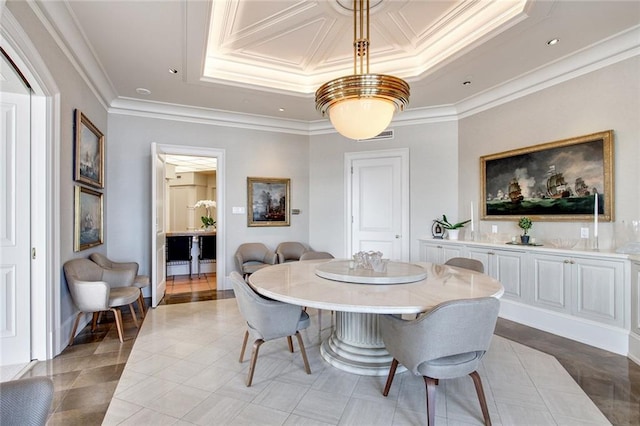 dining room featuring light tile patterned flooring, ornamental molding, and a raised ceiling