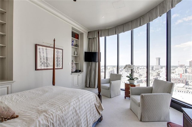 bedroom with light colored carpet and ornamental molding