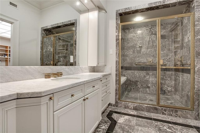 bathroom featuring an enclosed shower and vanity