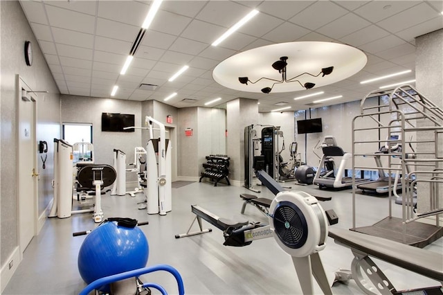 exercise room featuring a drop ceiling