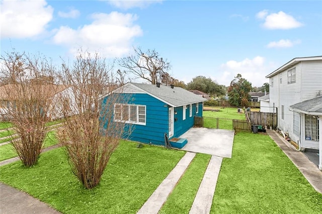 exterior space with a patio and a lawn