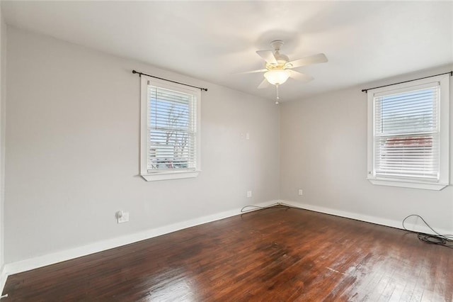 unfurnished room with ceiling fan and dark hardwood / wood-style flooring