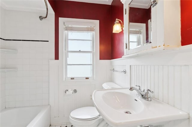 bathroom featuring sink, a wealth of natural light, and toilet