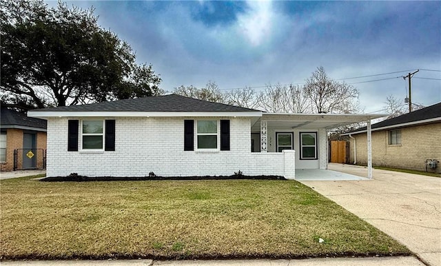 ranch-style home with a carport and a front lawn